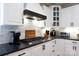 Beautiful kitchen features stainless steel gas cooktop, white cabinets and dark granite countertops at 804 Creek Bluff Rd, Rock Hill, SC 29732
