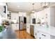 Bright kitchen features stainless steel appliances, white cabinets, hardwood floors and granite countertops at 804 Creek Bluff Rd, Rock Hill, SC 29732