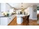 Spacious kitchen features stainless steel appliances, hardwood floors, white cabinets and an island with seating at 804 Creek Bluff Rd, Rock Hill, SC 29732