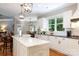 Eat-in kitchen showcases stainless steel appliances, white cabinets, dark countertops, and a large kitchen island at 804 Creek Bluff Rd, Rock Hill, SC 29732