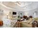 Spacious living room with a tray ceiling, ceiling fans, and access to dining area at 804 Creek Bluff Rd, Rock Hill, SC 29732