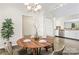 Cozy dining area with modern chandelier adjacent to the bright kitchen at 8724 Tweedsmuir Glen Ln, Charlotte, NC 28215