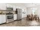 Bright kitchen features stainless steel appliances and a dining area with lots of natural light at 8724 Tweedsmuir Glen Ln, Charlotte, NC 28215