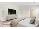 Modern main bedroom with a large TV, light-colored furnishings, and natural light at 8724 Tweedsmuir Glen Ln, Charlotte, NC 28215