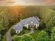 Stunning aerial view of a luxury home with a meticulously landscaped yard surrounded by lush greenery at 9110 Woodhall Lake Dr, Waxhaw, NC 28173