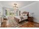 Spacious bedroom offers hardwood floors, natural light, and a seating area for relaxing at 9110 Woodhall Lake Dr, Waxhaw, NC 28173