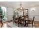 Formal dining room with a large chandelier, elegant furnishings, and ample natural light at 9110 Woodhall Lake Dr, Waxhaw, NC 28173