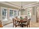 Sun-drenched dining room with views, crown molding and wood table creates a cozy atmosphere at 9110 Woodhall Lake Dr, Waxhaw, NC 28173