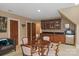 Entertainment space with a table, kitchenette, and built-in display cabinet at 9110 Woodhall Lake Dr, Waxhaw, NC 28173