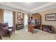 Bright home office with custom built-in shelving, desk, and comfortable seating area at 9110 Woodhall Lake Dr, Waxhaw, NC 28173
