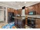 Modern kitchen with dark wood cabinets, granite countertops, stainless steel appliances, and a functional center island at 9110 Woodhall Lake Dr, Waxhaw, NC 28173