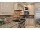 Gourmet kitchen with custom cabinetry, granite countertops, and stainless steel appliances at 9110 Woodhall Lake Dr, Waxhaw, NC 28173