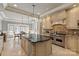 Open kitchen with island, stainless appliances, and adjacent breakfast nook create inviting space at 9110 Woodhall Lake Dr, Waxhaw, NC 28173