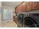 Spacious laundry room with modern washer and dryer, ample cabinetry, and natural light at 9110 Woodhall Lake Dr, Waxhaw, NC 28173