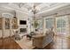 Bright living room boasts a coffered ceiling, elegant chandelier, built-in shelving and large windows at 9110 Woodhall Lake Dr, Waxhaw, NC 28173