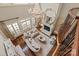 Bright living room with fireplace, chandelier, large windows, and elegant seating area at 9110 Woodhall Lake Dr, Waxhaw, NC 28173