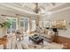 Open-concept living room showcases hardwood floors, large windows, and a seamless transition to the kitchen at 9110 Woodhall Lake Dr, Waxhaw, NC 28173