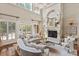 Elegant living room with a fireplace, large windows, and stylish, comfortable seating at 9110 Woodhall Lake Dr, Waxhaw, NC 28173