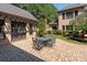 Outdoor patio with brick flooring, an umbrella-covered table, and lush landscaping at 9110 Woodhall Lake Dr, Waxhaw, NC 28173