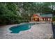 An inviting in-ground pool with beautiful brick pavers is surrounded by lush landscaping and a privacy fence at 9110 Woodhall Lake Dr, Waxhaw, NC 28173