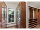 Well-organized walk-in closet with custom shelving, drawers, and natural light from the window at 9110 Woodhall Lake Dr, Waxhaw, NC 28173