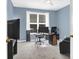 Cozy bedroom with blue walls, a window with blinds and curtains, and carpeted floors at 10104 Treetop Ln, Cornelius, NC 28031