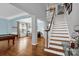 Welcoming foyer with beautiful hardwood floors and staircase to the second level at 10104 Treetop Ln, Cornelius, NC 28031