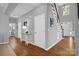 This foyer boasts hardwood floors, stairs, and a front door with sidelights that let in natural light at 10104 Treetop Ln, Cornelius, NC 28031