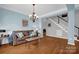 Cozy living room with hardwood floors, neutral walls, and comfortable seating at 10104 Treetop Ln, Cornelius, NC 28031