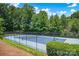Community tennis court with lush green surroundings, providing a great space for recreational play at 10104 Treetop Ln, Cornelius, NC 28031
