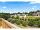 Scenic backyard view from a deck with lush greenery, water feature, and neighborhood homes in the background at 1033 12Th Avenue Nw Dr, Hickory, NC 28601