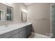 Bathroom featuring dual sinks, vanity with drawers and doors, and brushed nickel fixtures at 1033 12Th Avenue Nw Dr, Hickory, NC 28601