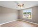 Bedroom features a ceiling fan and a window overlooking the neighborhood at 1033 12Th Avenue Nw Dr, Hickory, NC 28601