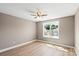Cozy bedroom featuring a ceiling fan and a window overlooking the neighborhood at 1033 12Th Avenue Nw Dr, Hickory, NC 28601
