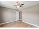 An inviting bedroom with light walls, hardwood floors, and a modern ceiling fan at 1033 12Th Avenue Nw Dr, Hickory, NC 28601