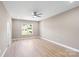 A bright bedroom featuring hardwood floors, neutral paint, and a window with neighborhood views at 1033 12Th Avenue Nw Dr, Hickory, NC 28601