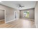 Large bedroom featuring hardwood floors, neutral paint, ceiling fan, and plenty of natural light at 1033 12Th Avenue Nw Dr, Hickory, NC 28601