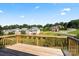 Relaxing view from a wooden deck overlooking neighborhood homes and green landscape under a sunny blue sky at 1033 12Th Avenue Nw Dr, Hickory, NC 28601