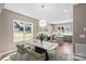 Open dining space with modern light fixture and table, flowing into kitchen with stainless appliances at 1033 12Th Avenue Nw Dr, Hickory, NC 28601