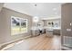 Open dining space with modern light fixture and table, flowing into kitchen with stainless appliances at 1033 12Th Avenue Nw Dr, Hickory, NC 28601
