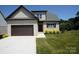 Charming brick home featuring a two-car garage, neat landscaping, and a well-maintained lawn at 1033 12Th Avenue Nw Dr, Hickory, NC 28601