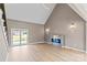 Bright living room featuring hardwood floors, fireplace, and access to the outdoor deck at 1033 12Th Avenue Nw Dr, Hickory, NC 28601