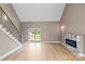 Bright living room featuring hardwood floors, fireplace, and access to the outdoor deck at 1033 12Th Avenue Nw Dr, Hickory, NC 28601
