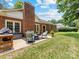 Backyard patio with outdoor seating, perfect for relaxing with a brick home at 1115 Berry Ridge Rd, Charlotte, NC 28270