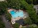Aerial view of community pool, surrounded by trees and lounge chairs at 1115 Berry Ridge Rd, Charlotte, NC 28270