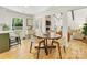 Open floor plan displaying the dining room's seamless flow into the living room with a fireplace at 1115 Berry Ridge Rd, Charlotte, NC 28270