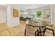 Open concept dining area with a wooden table and chairs flowing into a beautifully remodeled kitchen at 1115 Berry Ridge Rd, Charlotte, NC 28270