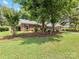 Landscaped front yard showcasing the brick exterior of the property, shaded by mature trees at 1115 Berry Ridge Rd, Charlotte, NC 28270