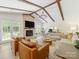 Bright living room featuring a brick fireplace, vaulted ceiling, and French doors to the outdoors at 1115 Berry Ridge Rd, Charlotte, NC 28270