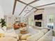 Spacious living room with vaulted ceilings, exposed beams, a cozy fireplace, and hardwood floors at 1115 Berry Ridge Rd, Charlotte, NC 28270